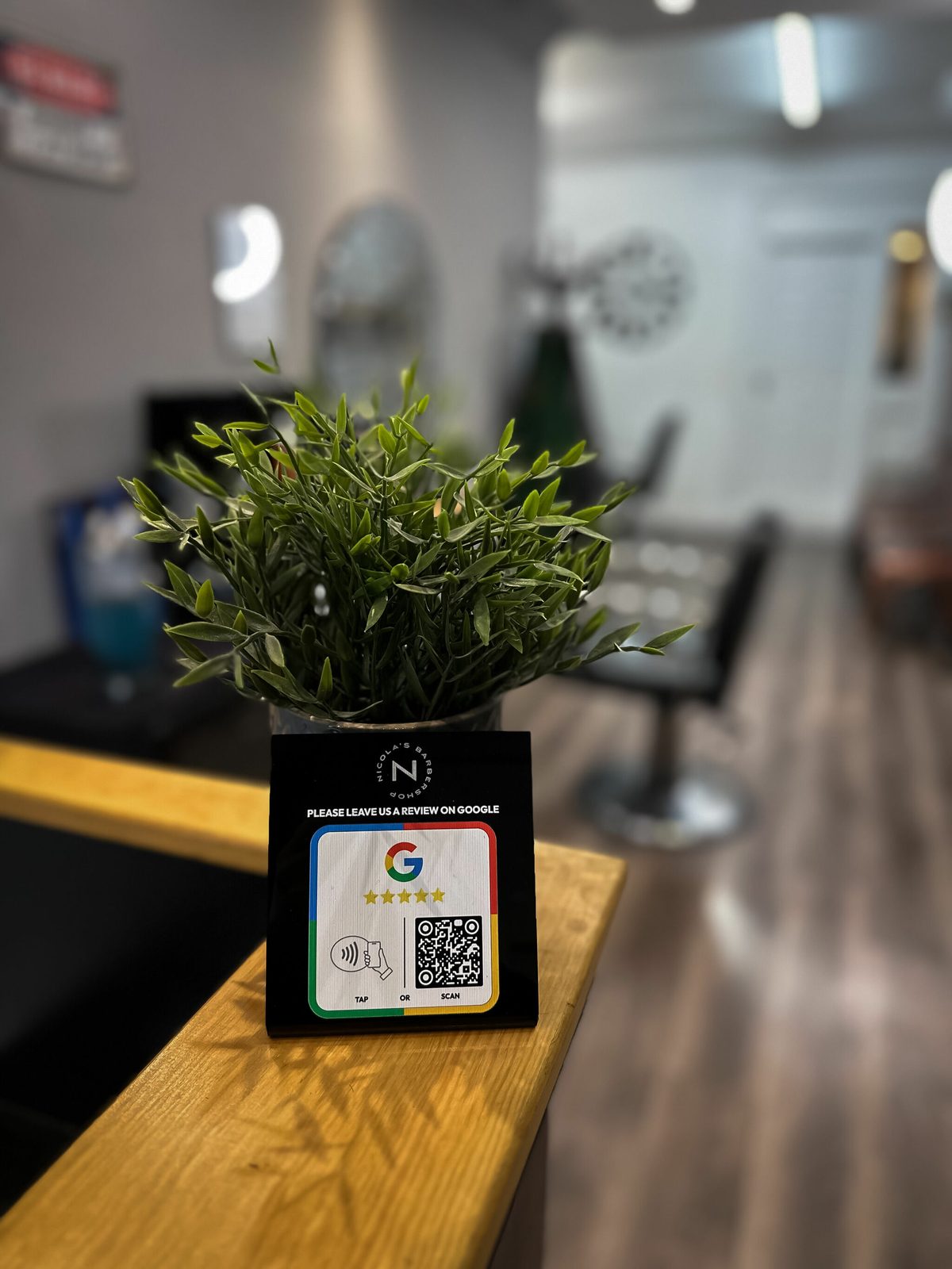 Google review QR sign and plant on the reception counter